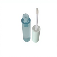 Tube de gloss à lèvres rond en plastique transparent avec applicateur magique et option de logo personnalisé pour l'emballage cosmétique