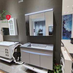 Nouvelle armoire de salle de bain blanche avec corps de meuble à trois portes et lavabo gris sur comptoir. - Product Image 1