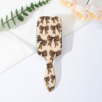 Brosse à cheveux démêlante portable style Coquette avec motif nœud léopard et coussin d'air, peigne de massage à palettes pour femmes