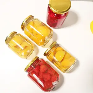 In scatola di vetro della bottiglia rotonda con un vuoto coperchio può essere cotto a vapore ad alta temperatura resistente di frutta pesca gialla sigillati in scatola