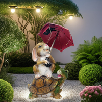 Statue de jardin solaire Lapin de Pâques extérieur, lapin assis sur une tortue, tenant un parapluie, avec guirlande lumineuse