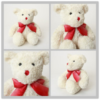Ours en peluche doux blanc avec un joli nœud rouge en forme de ruban
