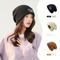 Vente en gros de bonnets en laine personnalisés pour hommes et femmes, épais et chauds pour l'hiver, avec protection des oreilles, double face avec fourrure