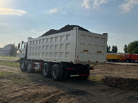 Самосвал SINO HOWO NX 8x4 для тяжелых условий эксплуатации с кузовом дугообразной формы, обеспечивающий минимальное остаток материала в кузове, для горнодобывающей промышленности