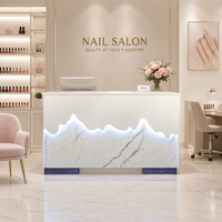 Comptoir de manucure en marbre au design moderne de l'usine de Foshan, table de réception pour salon de beauté