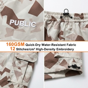 ผู้ผลิตเสื้อผ้า OEM รับผลิตกางเกงขาสั้นผู้ชายแบบสั่งทำพิเศษ พิมพ์ลายแบบ Sublimation หลายกระเป๋า ปักลายแบบ Flat Embroidery ทรงหลวม สไตล์ลำลอง ลายพราง สำหรับฤดูร้อน - Product Image 2