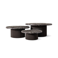 Table basse ronde RH MULHOLLAND, en bois massif avec base en piédestal cannelé, design moderne et minimaliste pour salon