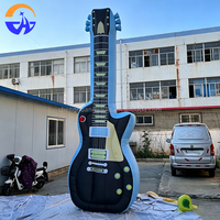 Guitare gonflable publicitaire personnalisée en tissu Oxford avec ventilateur intégré pour la décoration de scène de festival de musique
