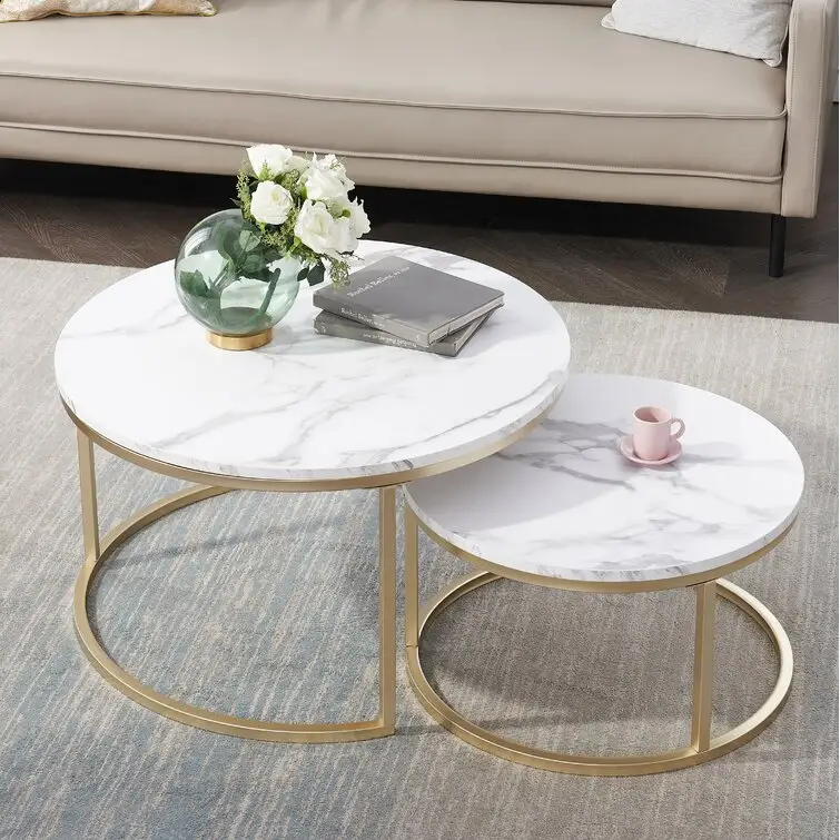 2 Nesting Tables features a gleaming gold base and marble-inspired tops coffee table home furniture