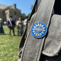 Maßgefertigtes blaues Hartemaille-Abzeichen mit goldgeprägtem Sonnen-Handschlag-IHP-Logo, organisatorisches Gedenk-Metallabzeichen, antik-modern