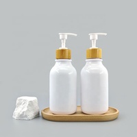 Flacon de shampooing vide circulaire personnalisé en PET blanc avec bouchon pompe en bambou pour lotion et sérum de soin de la peau