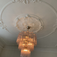 Lustre en verre rose doré de luxe, à plusieurs niveaux, avec abat-jour en cristal à bords festonnés, accents floraux en laiton, éclairage à économie d'énergie