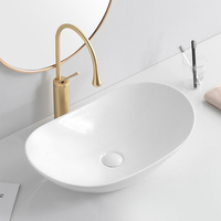 Lavabo en céramique noir mat de style moderne, lavabo de comptoir ovale, lavabo de salle de bain noir