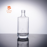 Bouteille en verre cylindrique de 500 ml avec logo goutte d'eau en relief, idéale pour l'emballage du gin, de la vodka et du whisky