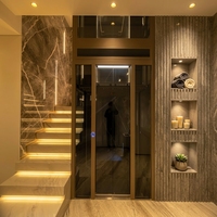 Ascenseur hydraulique à dos à deux étages pour intérieur avec portes manuelles, vitrage panoramique, construction en acier inoxydable, design contemporain