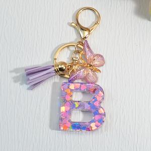 Popular venta directa de fábrica llavero de resina rosa púrpura 26 letras brillo pequeño colgante mariposa borla en forma de corazón para pequeño - Product Image 5