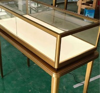 Vitrine d'îlot de luxe en verre noir et or, durable, avec éclairage LED haut de gamme pour la présentation de bijoux fins dans les centres commerciaux
