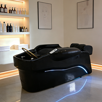 Lit de lavage électrique de luxe pour salon de coiffure moderne, avec cadre noir, fonction massage et circulation d'eau pour spa capillaire