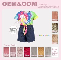 Vente en gros de vêtements pour poupées personnalisés de 18 pouces, ensemble décontracté pour poupée fille, t-shirt tie-dye arc-en-ciel, short en jean bleu foncé, vêtements pour poupées OEM, vêtements pour poupées en vrac