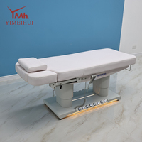 Lit de massage électrique de luxe à 4 moteurs avec commande au pied pour salon de beauté et clinique, avec lumière d'ambiance