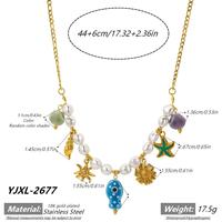 Collier de plage pour femme en acier inoxydable plaqué or 18 carats style bohème avec breloques coquillage, étoile de mer, tournesol et œil de diable