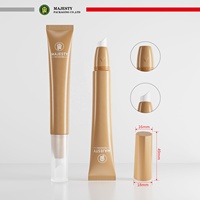 Tube cosmétique en plastique PE avec tête de massage en acier inoxydable et applicateur à brosse pour gloss et lotion
