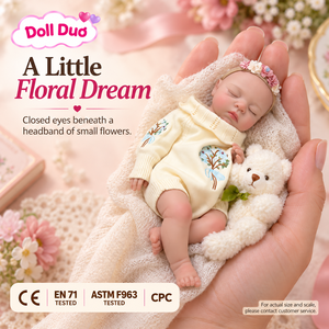 ตุ๊กตาเด็กเกิดใหม่ซิลิโคนขนาด 6 นิ้ว DollDuo แบบสั่งทำพิเศษ ชุดนอนลายดอกไม้สีครีม วาดลายด้วยมือ ของขวัญวันฮาโลวีนสำหรับเด็ก - Product Image 1