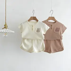 Vente en gros de vêtements d'intérieur confortables vêtements unisexes pour enfants vêtements d'extérieur décontractés unis costume de tous les jours costume d'été pour garçons filles manches courtes