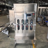 Remplisseuse semi-automatique à gravité pneumatique 0,6 0,8 MPa pour le remplissage de boissons, de l'eau minérale, de l'eau potable, avec contrôle de la vanne de remplissage