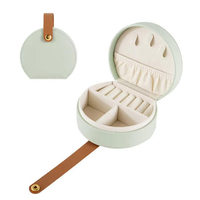 Boîte à bijoux ronde miniature avec poignée en cuir PU, petite boîte à bijoux portable de voyage pour femmes et filles, organiseur de rangement pour bijoux