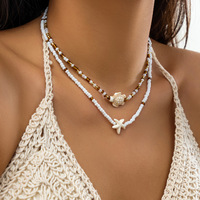 Collier tendance en laiton tressé avec pendentif étoile de mer, tortue marine, coquillage et perle, chaînes de perles de riz colorées pour femmes UIONEN 1370