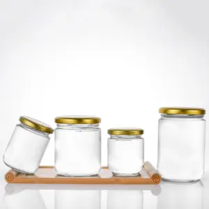 Pot en verre transparent rond à prix de gros promotionnel pour confiture, miel et cornichon avec couvercle en métal doré