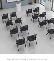 Chaise de formation pliante ergonomique et respirante en maille verte avec dossier, cadre métallique, tablette d'écriture, accoudoirs fixes, design moderne pour conférence