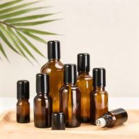 Bouteilles à bille en verre ambré de haute qualité avec boîtier noir et bille en acier inoxydable pour huiles essentielles
