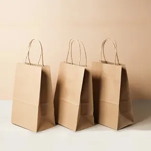 Bolsas de compras de papel Kraft de cartón con asa de cuerda de cinta, embalaje de ropa de regalo de lujo ecológico biodegradable