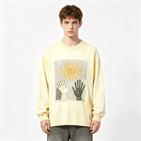 T-shirt à manches longues col rond Butter Wash, imprimé graphique rétro soleil, bords effilochés, coupe oversize, style streetwear