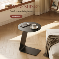 Table basse ronde moderne avec plateau en métal et structure en acier, design minimaliste mobile pour salon et salle à manger