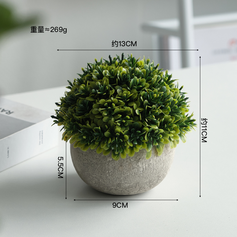 Bouteille ronde grise avec de petites feuilles vertes