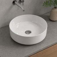 Lavabo en céramique rond à profil bas moderne de 120 mm de hauteur avec drain pour usage hôtelier, à poser sur comptoir ou à fixer au mur
