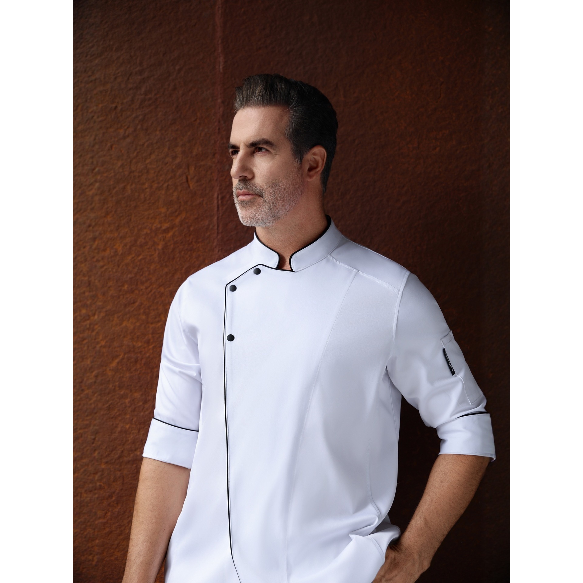 White jacket with black trim and short sleeves, black apron