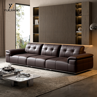 Canapé d'angle minimaliste italien en cuir véritable, trois places, design à dossier haut et accoudoirs droits, rembourrage en éponge