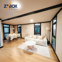 ZYBOX Vente directe usine Maison conteneur extensible préfabriquée en grain de bois de 20 pieds et 40 pieds, 2 chambres, modulaire, pliable, compacte, avec escalier, terrasse et porche