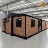 Maison conteneur extensible à effet bois avec structure en acier noir, maison mobile préfabriquée moderne pour habitation et bureau