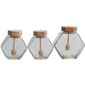 Tarro de miel único con cuchara de madera, tarro de vidrio hexagonal al por mayor para miel - Product Image 1