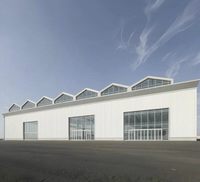 Bâtiment industriel préfabriqué en structure acier avec toit en dents de scie et éclairage naturel en verre