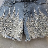 Shorts en jean pour femme, taille haute, ornés de perles, sexy, à sequins, avec ourlet en dentelle flamboyante, effet vieilli et effiloché, collection été 2026, vente en gros, tendance
