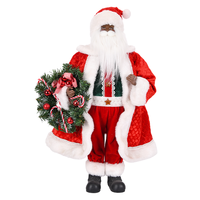 Figurine de Père Noël en noir avec manteau rouge matelassé et couronne de cannes en sucre pour la décoration de Noël à l'entrée de la boutique