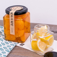 Vente en gros d'emballage de pots de miel pot de conserve carré bouteille vide mini pots de confiture de miel en verre carré avec couvercles noirs