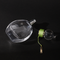 Logo personnalisé de gros 50ml oblate atomiseur vaporisateur de parfum en verre avec bouchon à bille ronde avec processus d'enroulement vert Surlyn