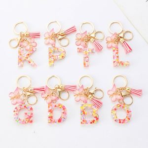 Porte-clés personnalisé avec nom, en résine rose, breloque initiale scintillante en résine à 26 lettres avec pompon papillon, accessoire décoratif pour sacs - Product Image 1